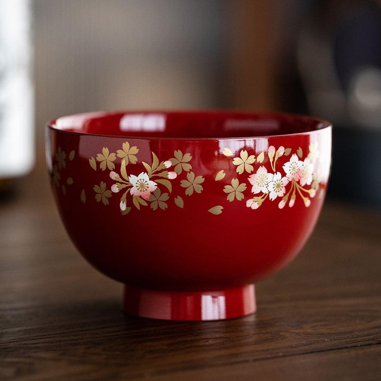 Close-up of red and black cherry blossom lacquerware bowls