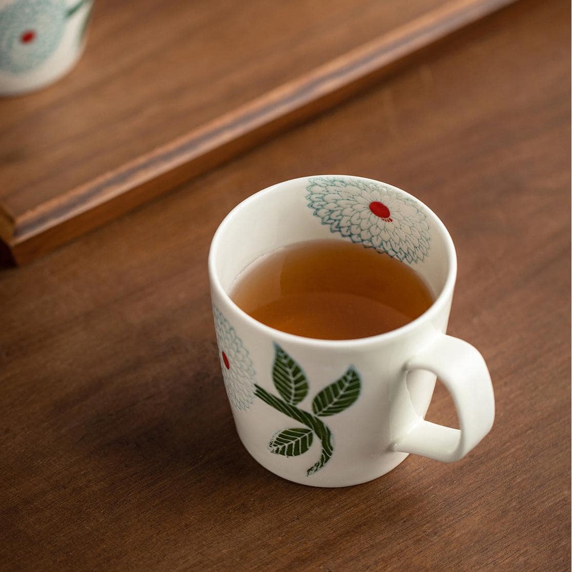 Hasami Ware tea set including mugs and tea strainer.