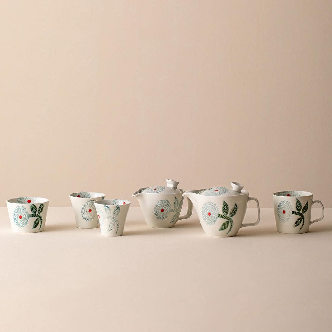 Elegant ceramic mugs with intricate floral patterns.