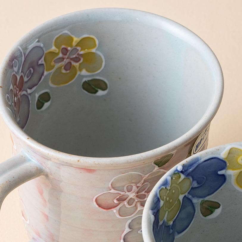 Close-up of ceramic mug showcasing hand-painted flowers