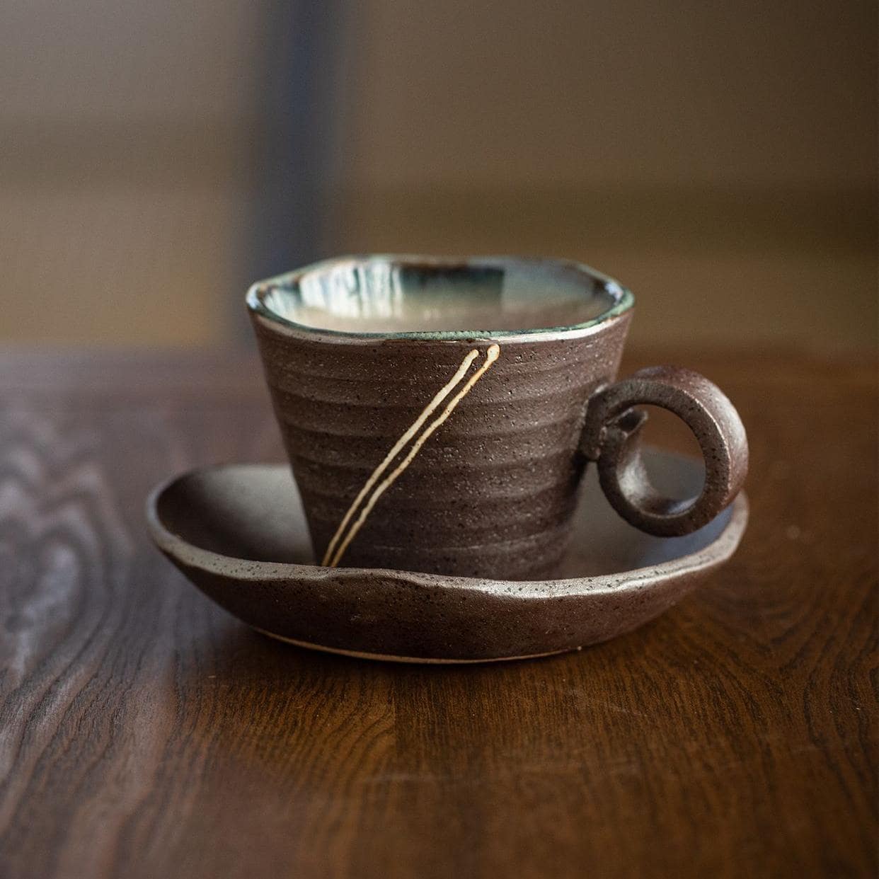 Artistic handcrafted ceramic tea cup with saucer.