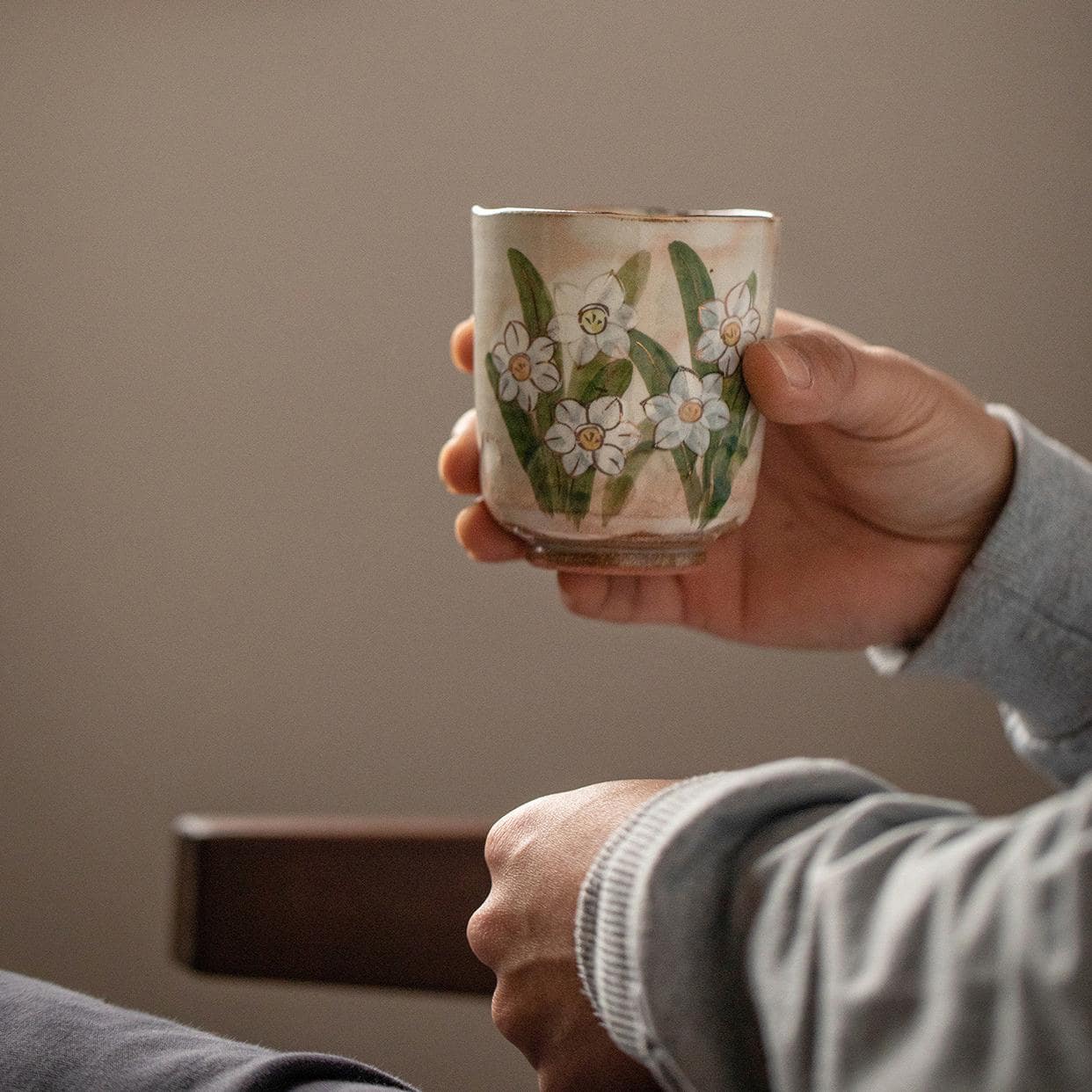 Close-up of artistic blue hydrangea design on a ceramic cup.