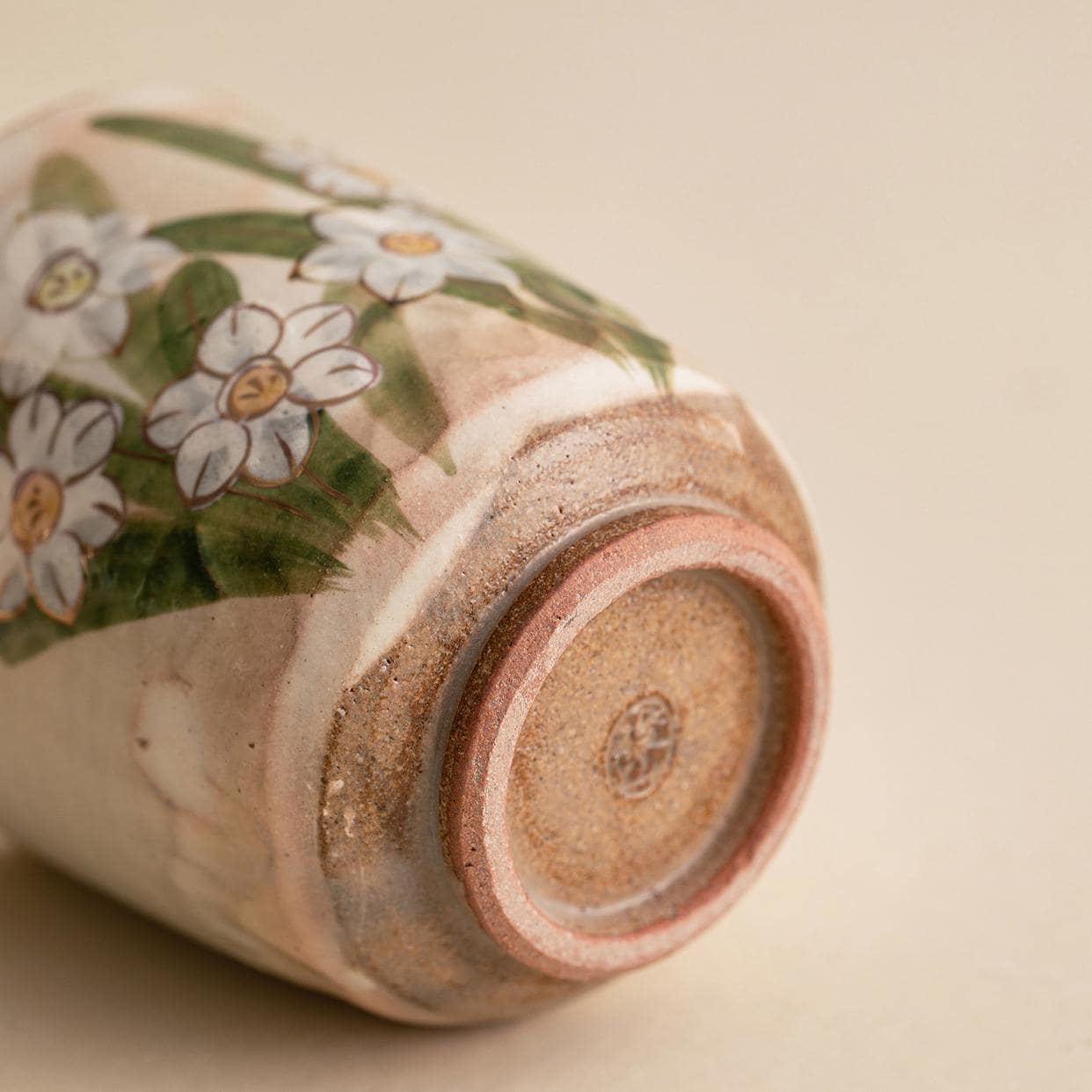 Unique hand-painted ceramic tea cup with daffodil pattern.