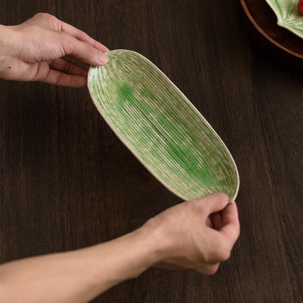 Stacked leaf-inspired ceramic plates showcasing eco-friendly design