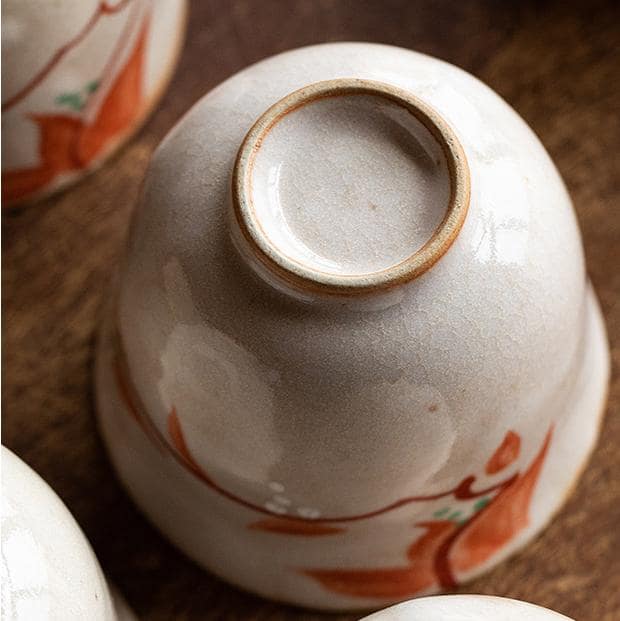 Close-up of hand-painted floral design on ceramic tea cup