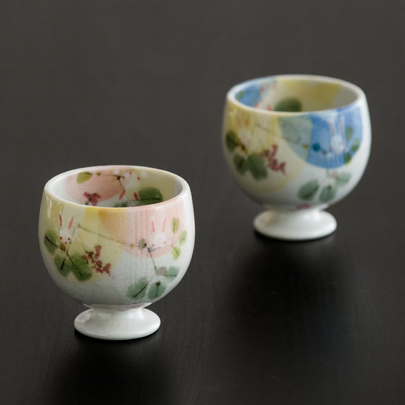 Miniature hand-painted ceramic cup with pastel floral design