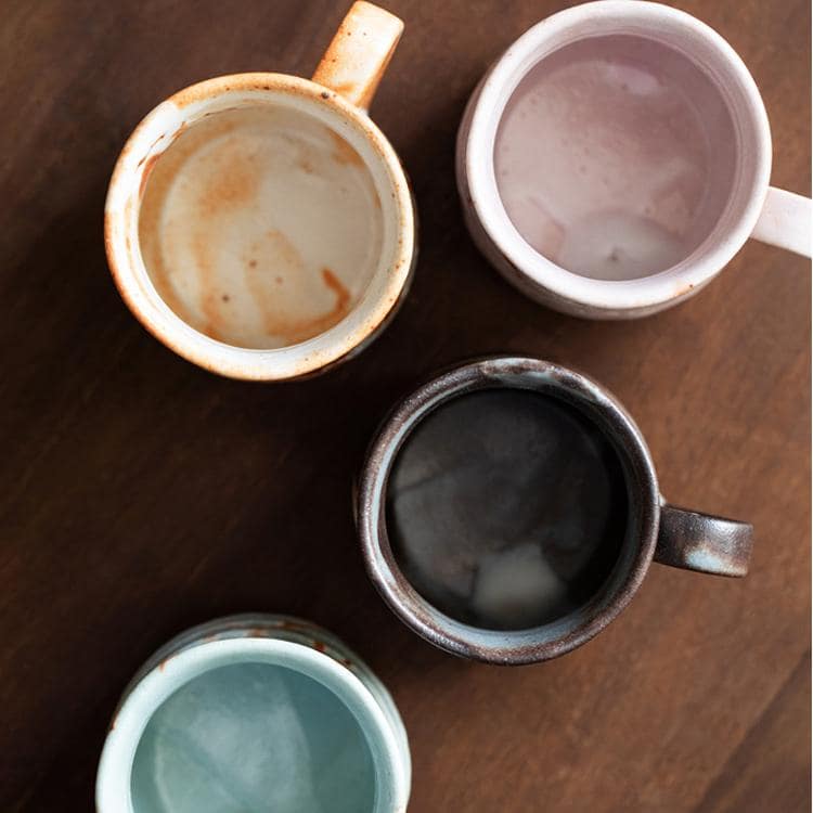 Top view of handmade ceramic mugs in assorted colors