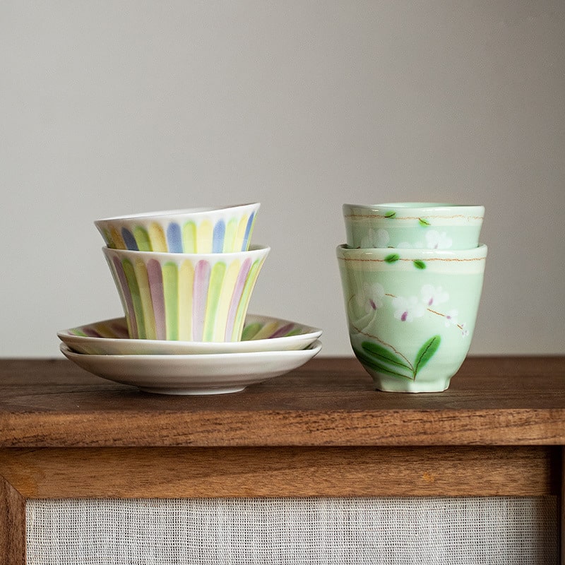 Hand-painted ceramic tea cups with floral design