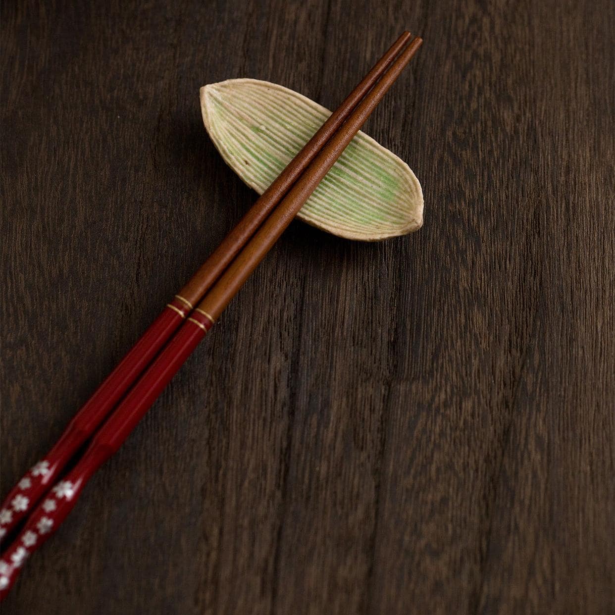 Leaf-shaped ceramic plates with green glaze and intricate texture