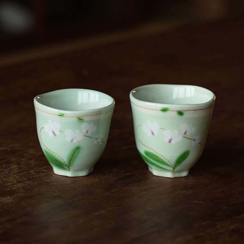 Pastel-striped ceramic coffee cup and saucer set