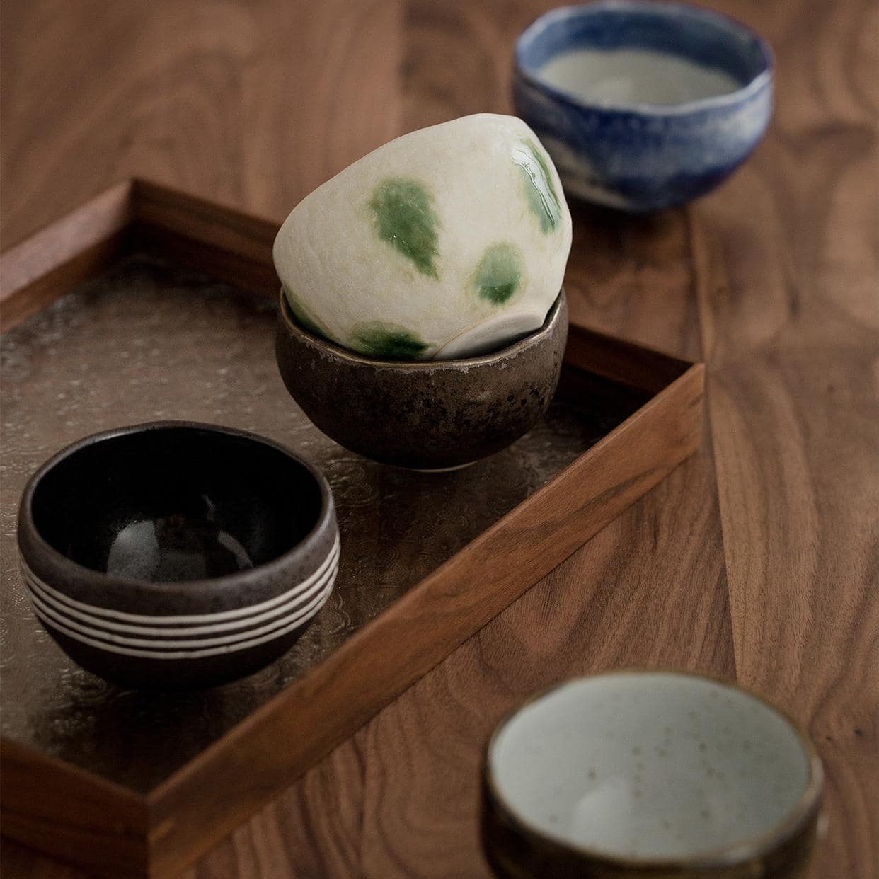 Stylish handmade ceramic bowls on a wooden table