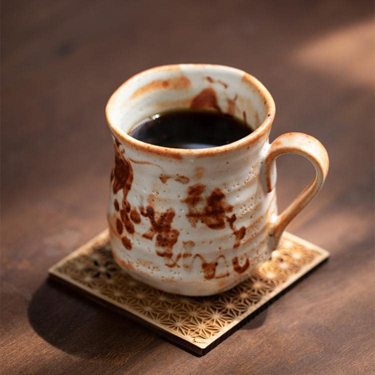 Rustic handcrafted ceramic mug with unique patterns