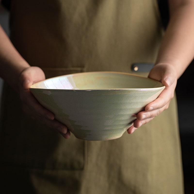 Elegant ceramic bowl held by hands