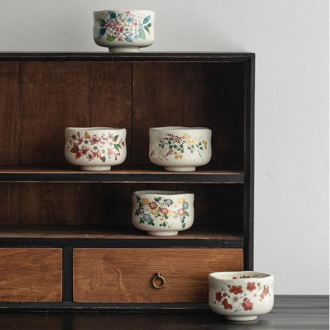 Hand-painted Japanese ceramic cups in elegant floral patterns