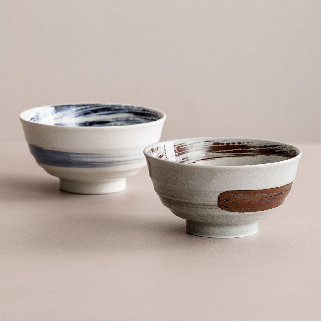 Collection of handcrafted ceramic bowls in various patterns and colors