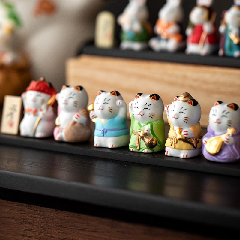 Vibrant lucky cat sculptures in colorful attire