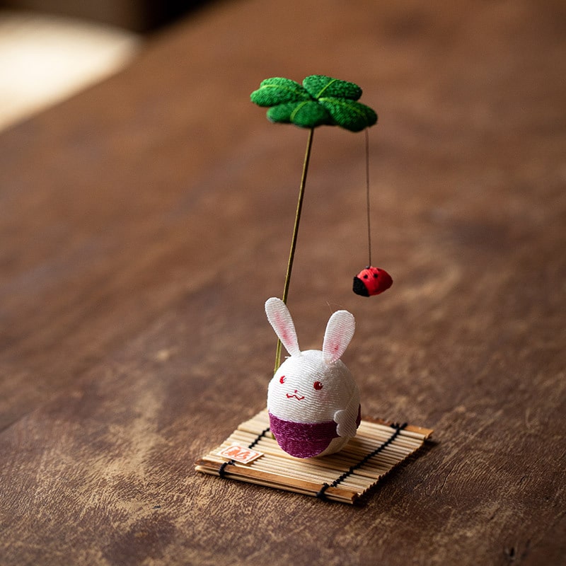 Close-up of a rabbit ornament with embroidered details.