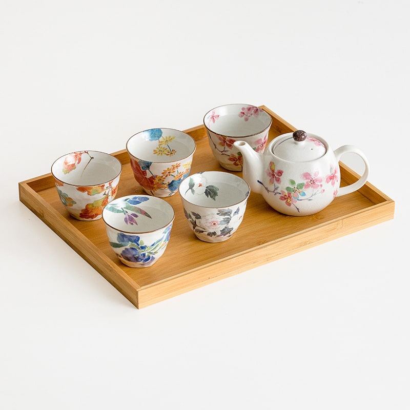 Elegant teapot set displayed on a wooden serving tray