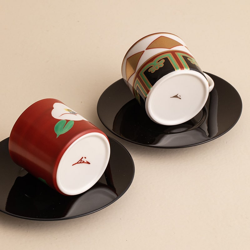 Handcrafted Mino ware coffee cups with intricate red designs.
