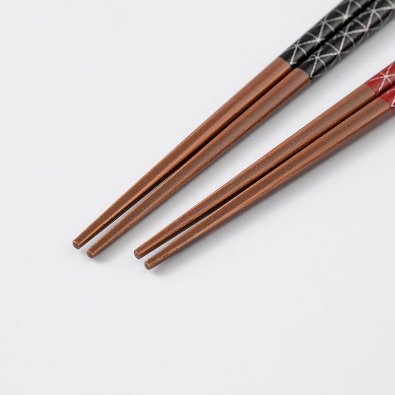 Durable wooden chopsticks with pointed tips for a secure grip.