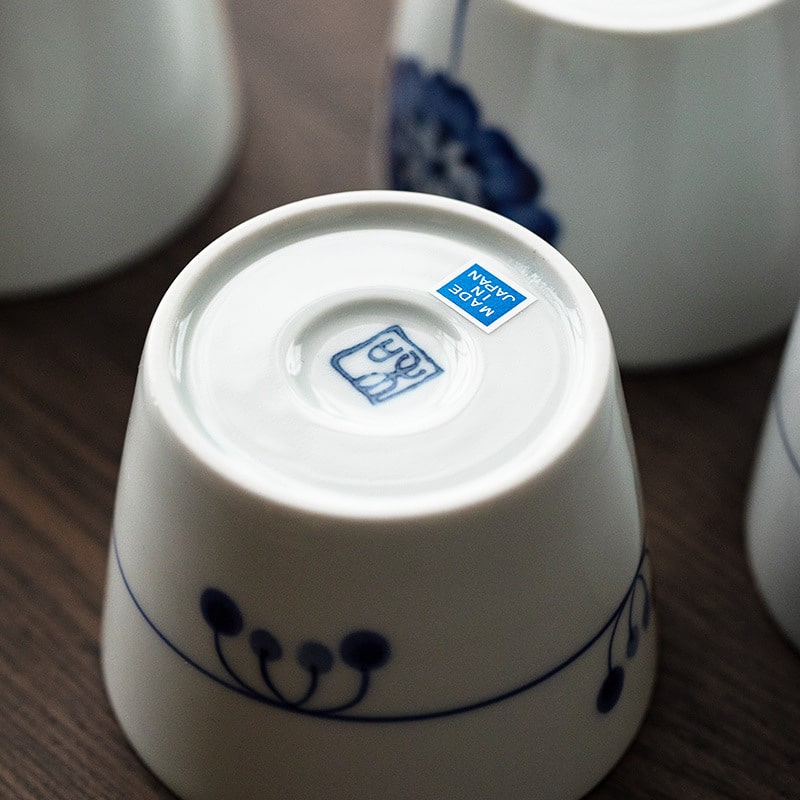 Close-up of the base of a porcelain tea cup with Japanese craftsmanship details.