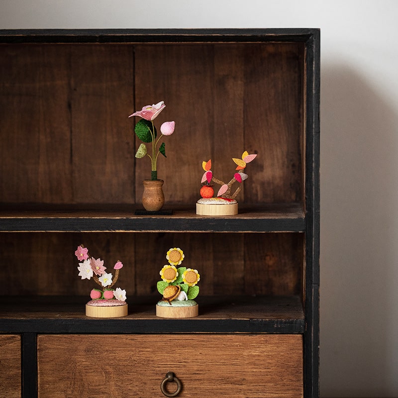 Cherry blossom and sunflower decor set on a shelf