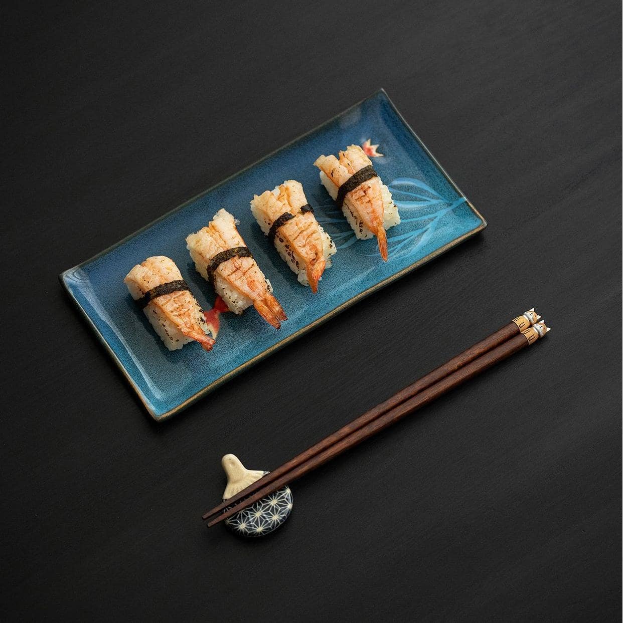 Wooden chopsticks with cute cat and bear designs on white surface