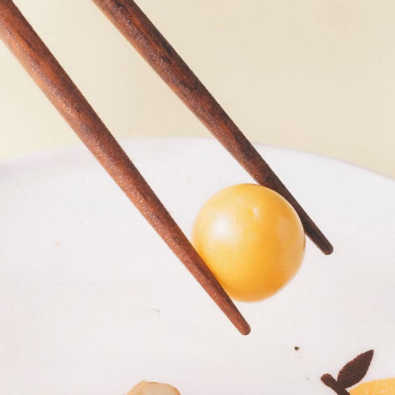 Close-up of hand-painted bunny design on wooden chopsticks