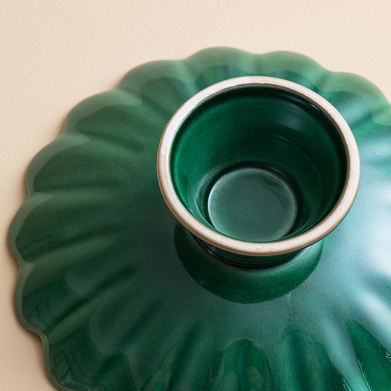 Artistic Japanese chrysanthemum-style ceramic tableware on a wooden table.