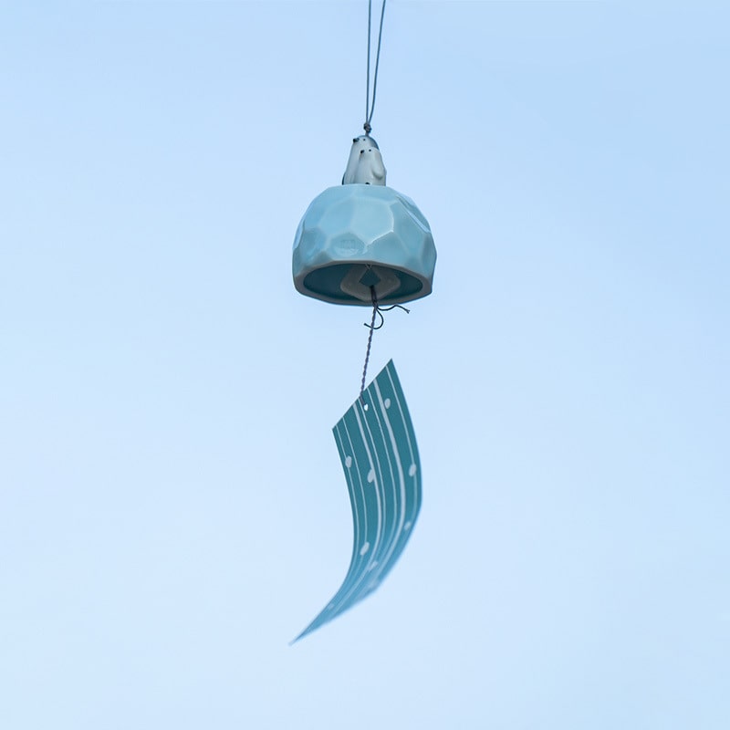 Close-up of handcrafted ceramic animal wind chime.