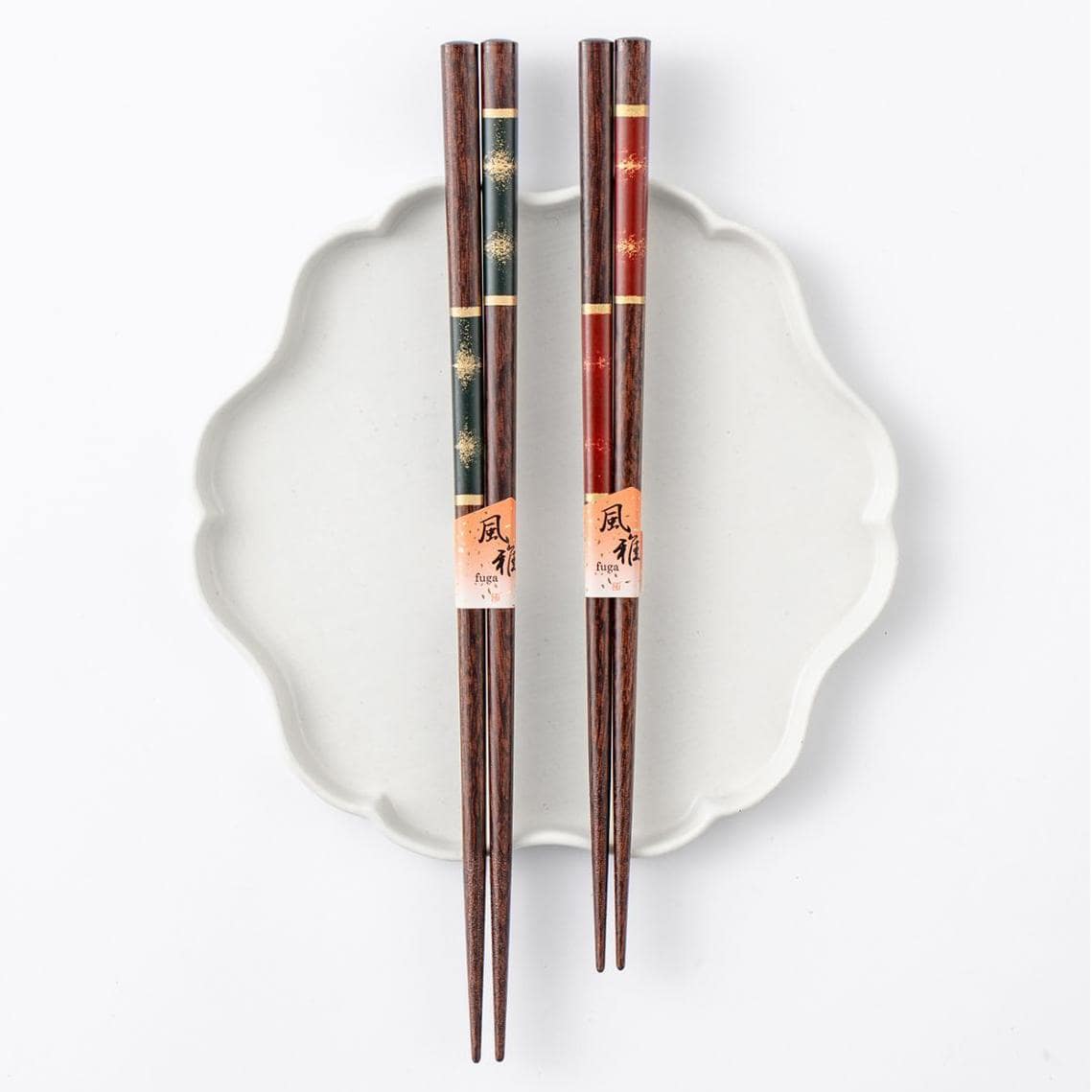 Close-up of gold-inlaid wooden chopsticks in red and green