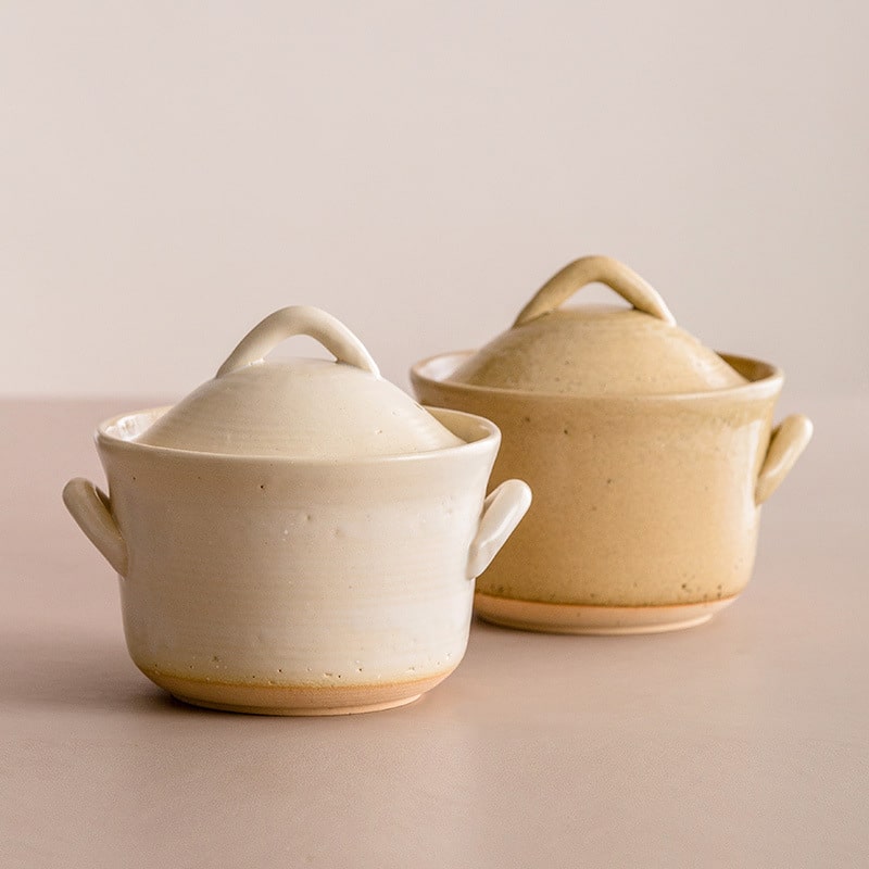 Handcrafted beige ceramic casserole with lid.