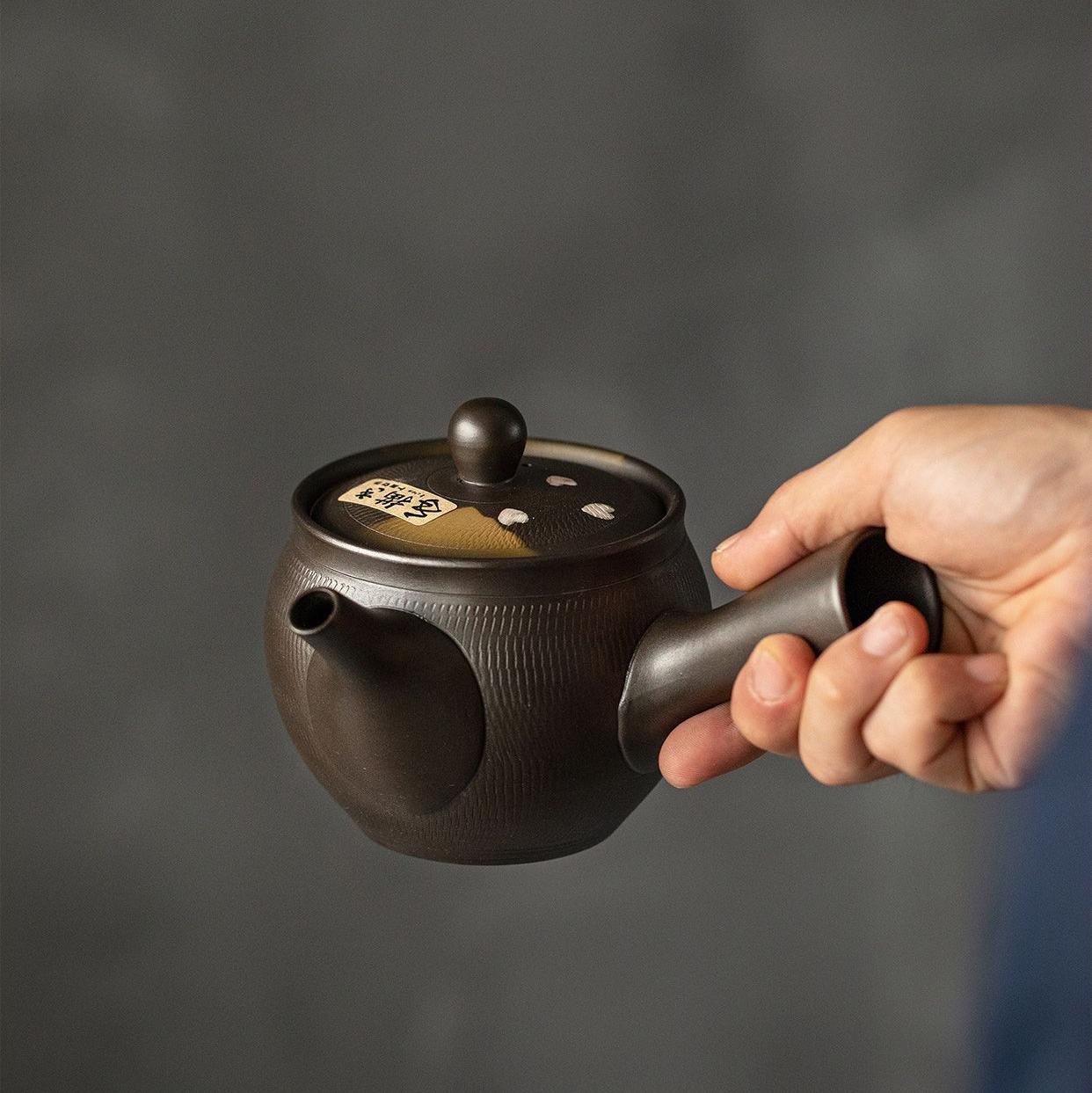 Elegant Japanese teapot on a wooden shelf