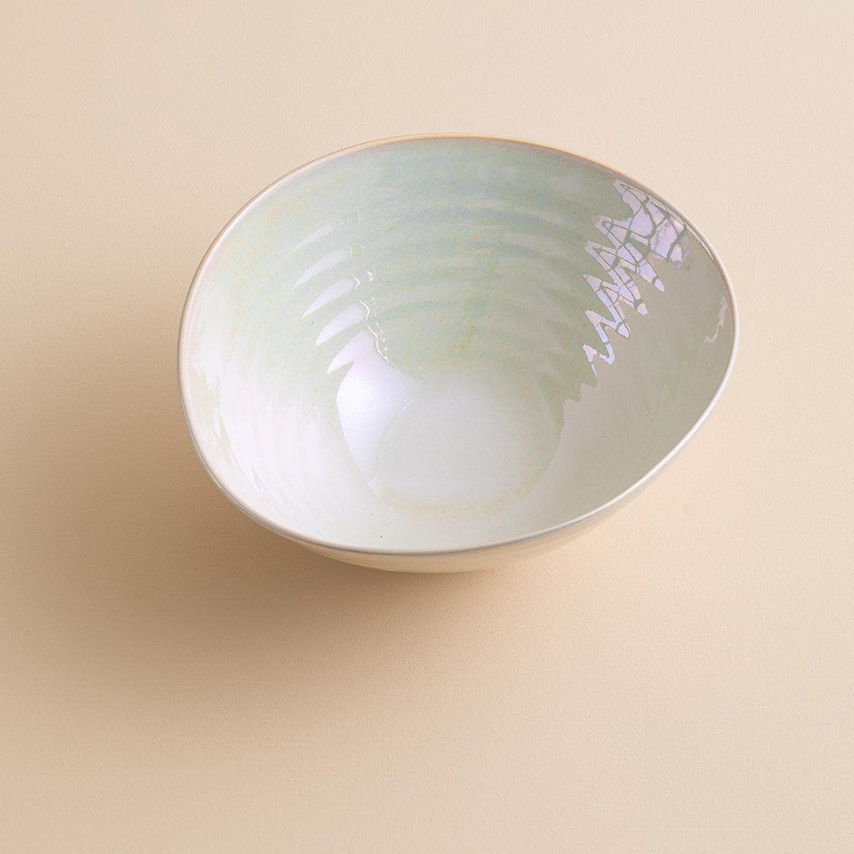 Iridescent ceramic bowl on wooden table