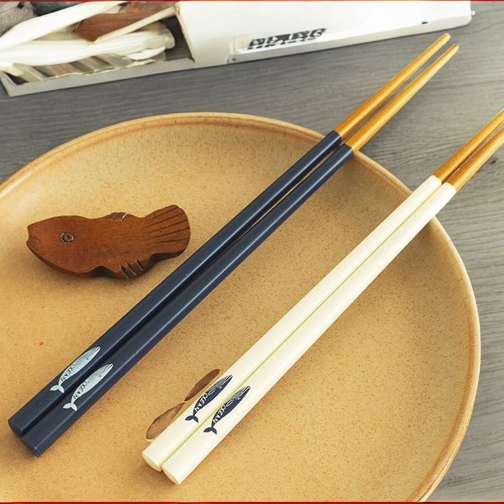 Elegant Japanese chopsticks with ocean-themed design on a plate