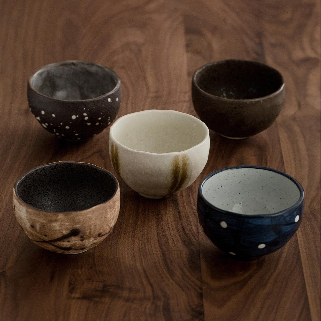 Stylish handmade ceramic bowls on a wooden table