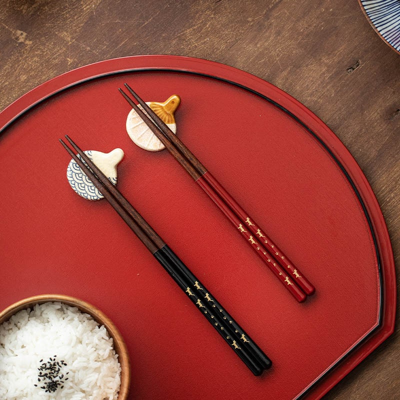 Luxury red and black chopstick set on a red dining mat