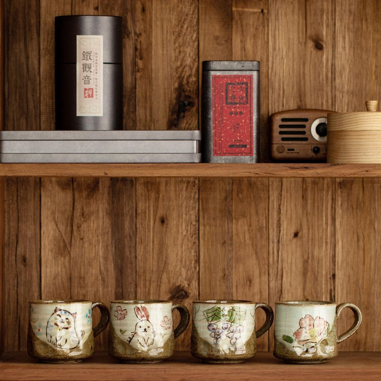 Collection of whimsical hand-painted cups with animal designs on a shelf.