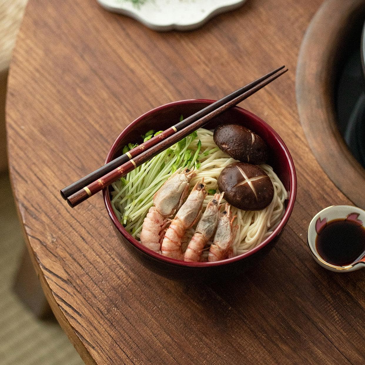 Luxurious wooden chopsticks with gold details on white plate