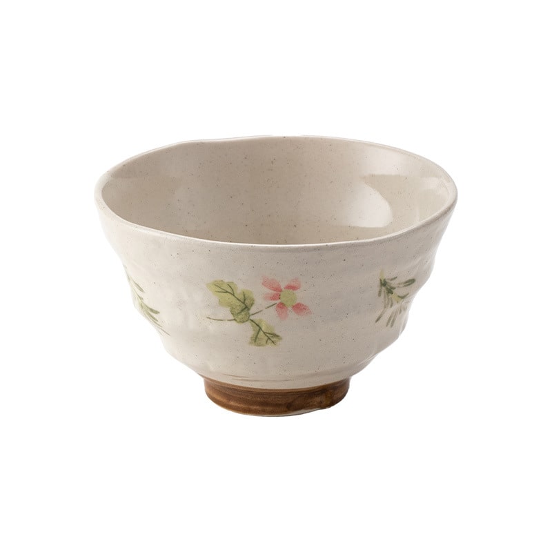 Pair of artisan floral ceramic bowls against neutral background