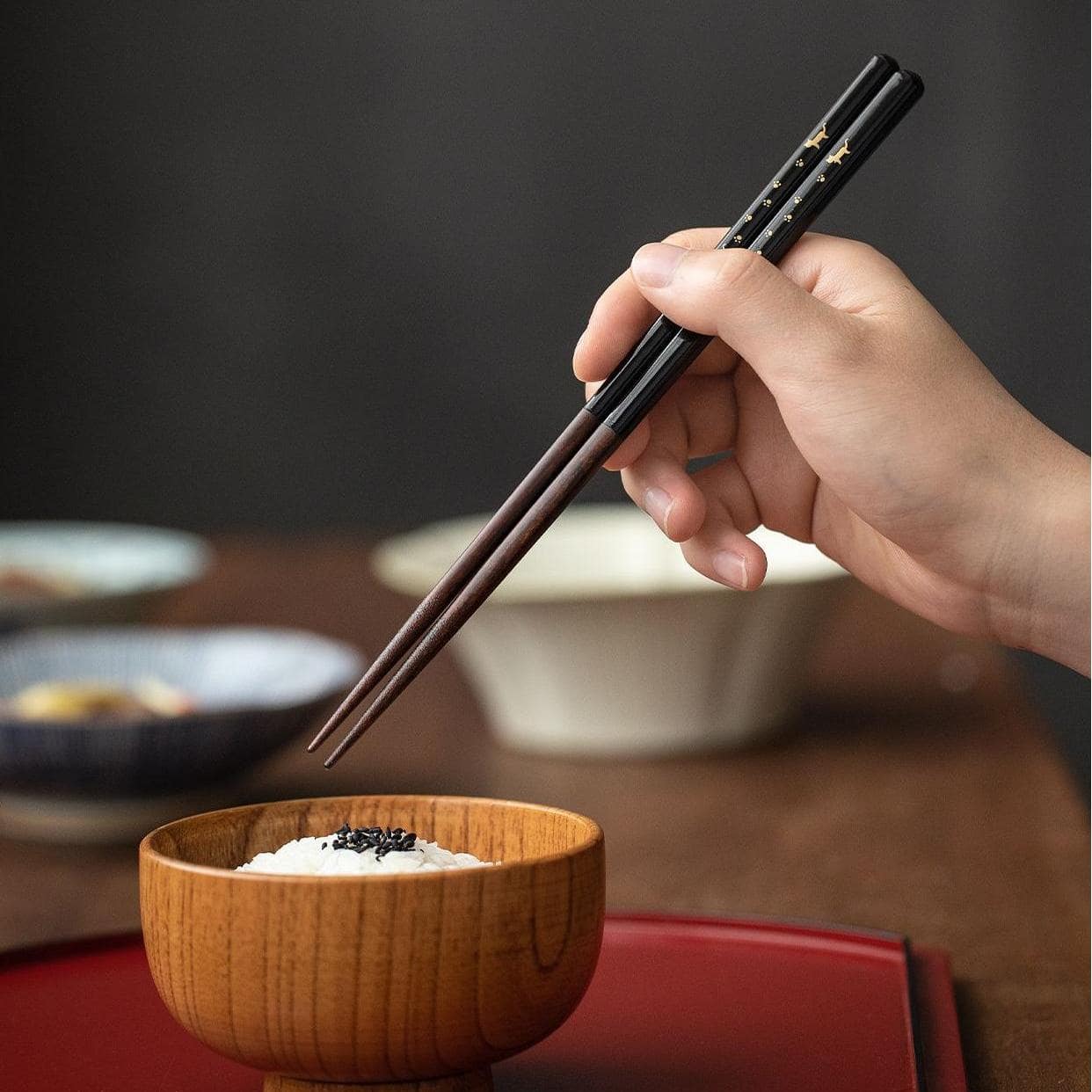 Reusable wooden chopsticks displayed with traditional dinner setting