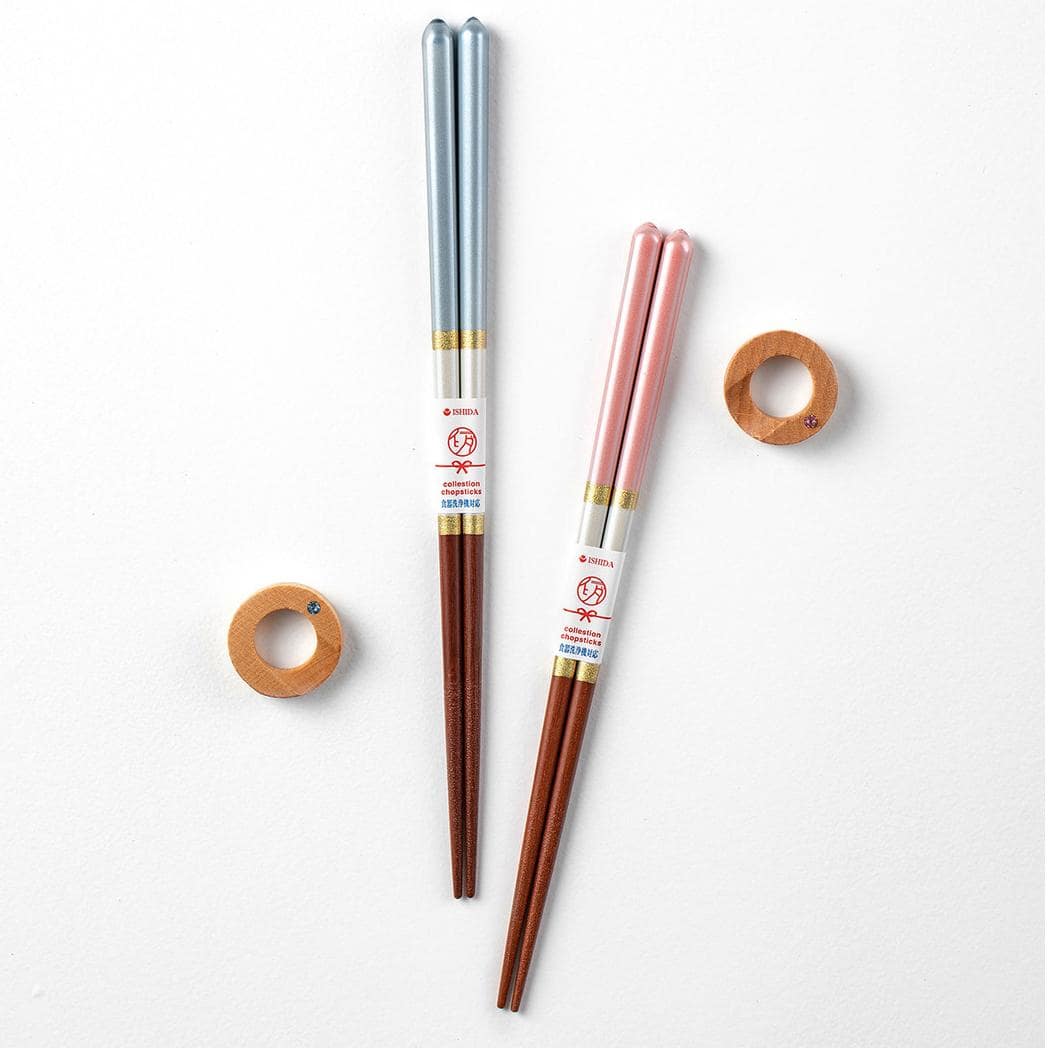 Close-up of durable wooden chopsticks with gold accents and smooth texture.