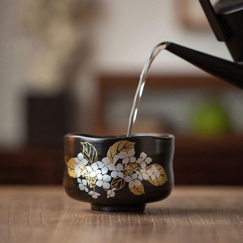 Hand-painted Japanese ceramic cups in elegant floral patterns