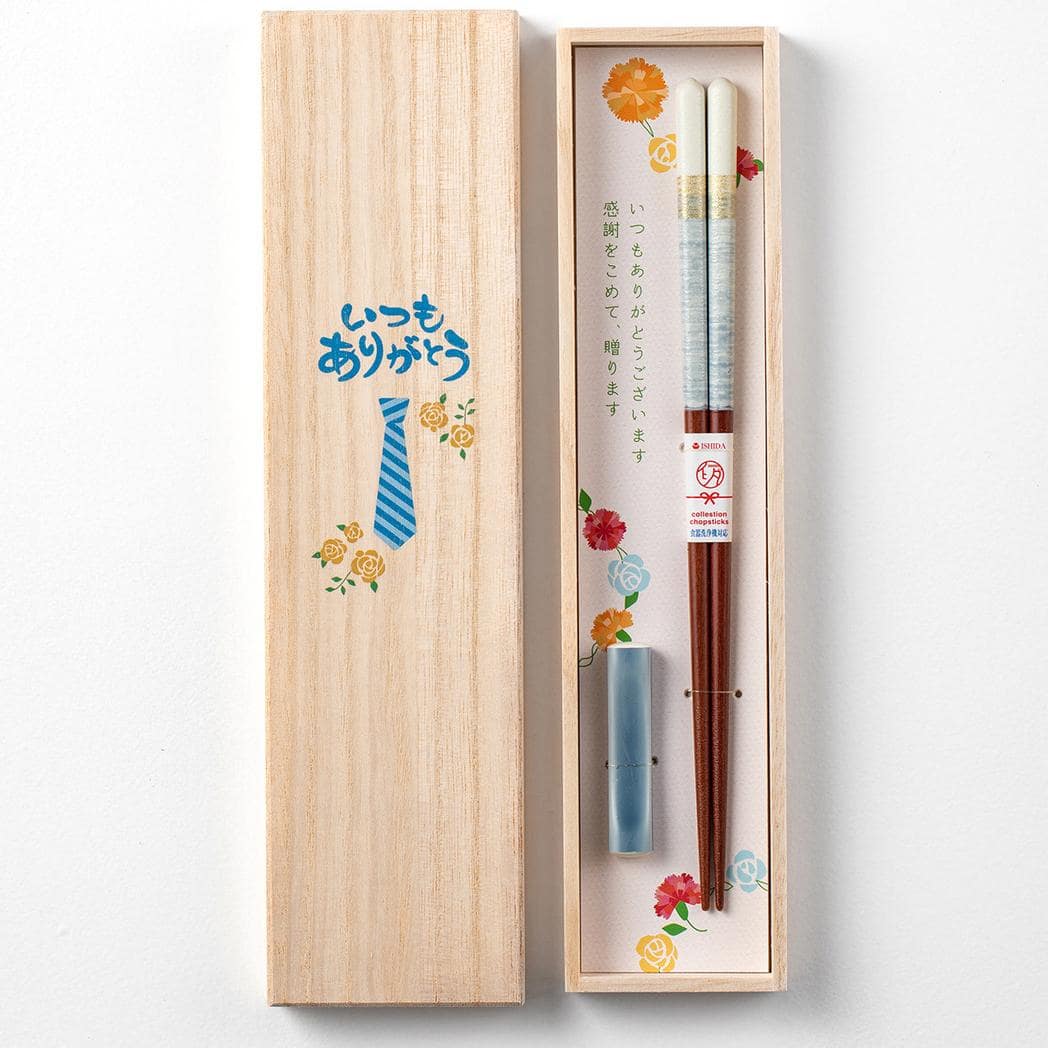 Elegant wooden chopsticks set paired with sushi and wooden rests.