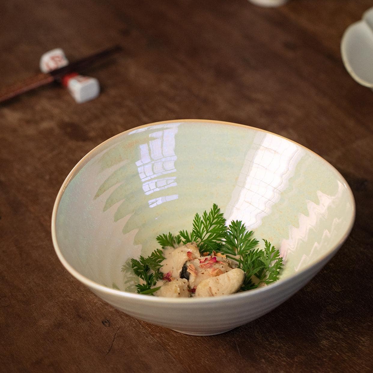 Iridescent ceramic bowl on wooden table