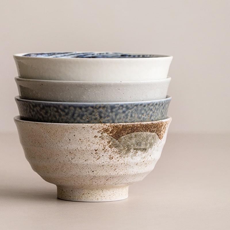 Stack of Japanese artisan ceramic bowls with unique glazes