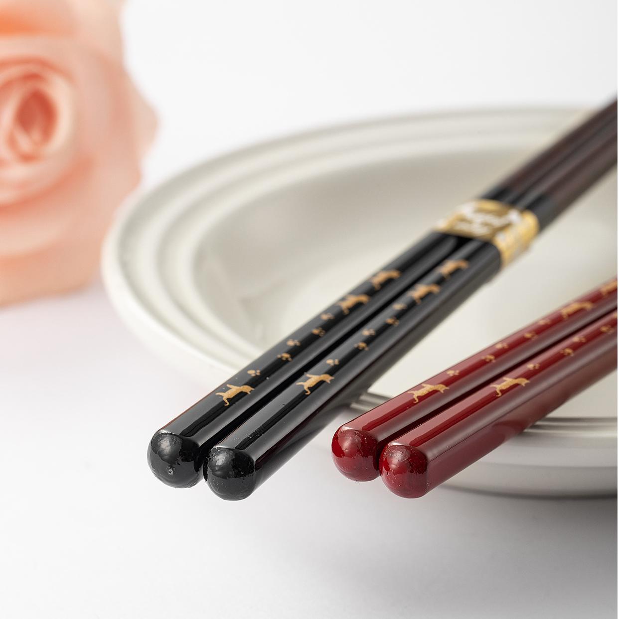 Reusable wooden chopsticks displayed with traditional dinner setting