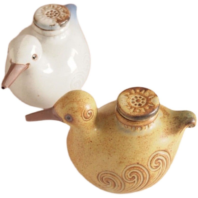 Japanese pottery oil dispenser with charming bird design.