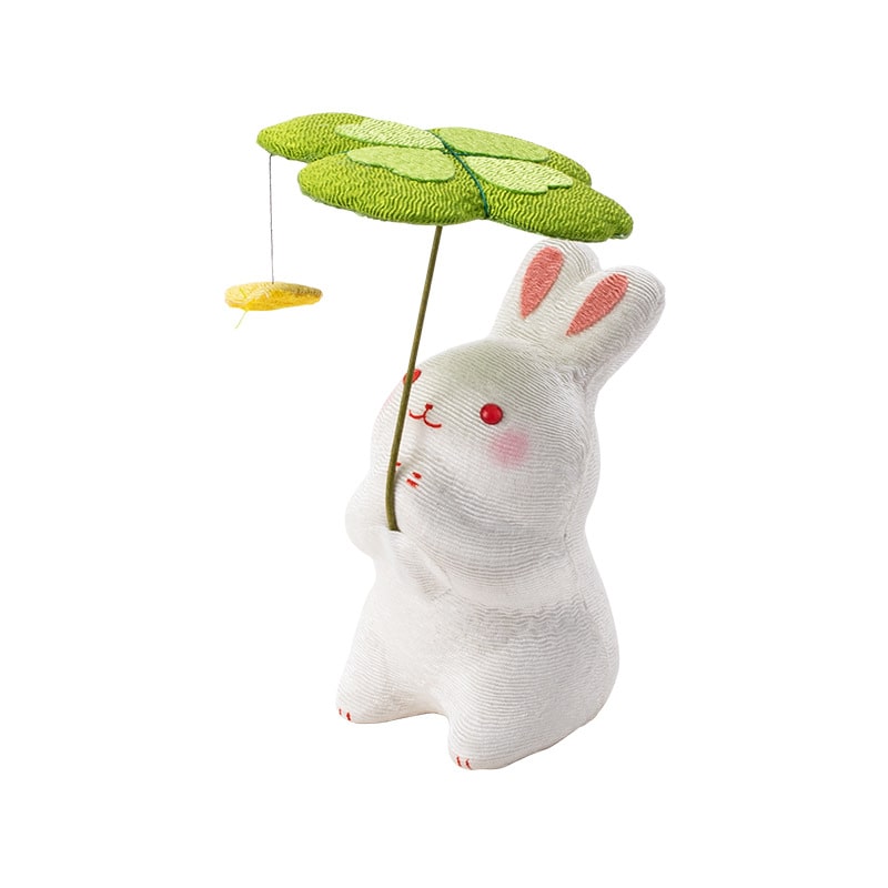 Longhutang dog figurine with clover umbrella and ladybug accent.