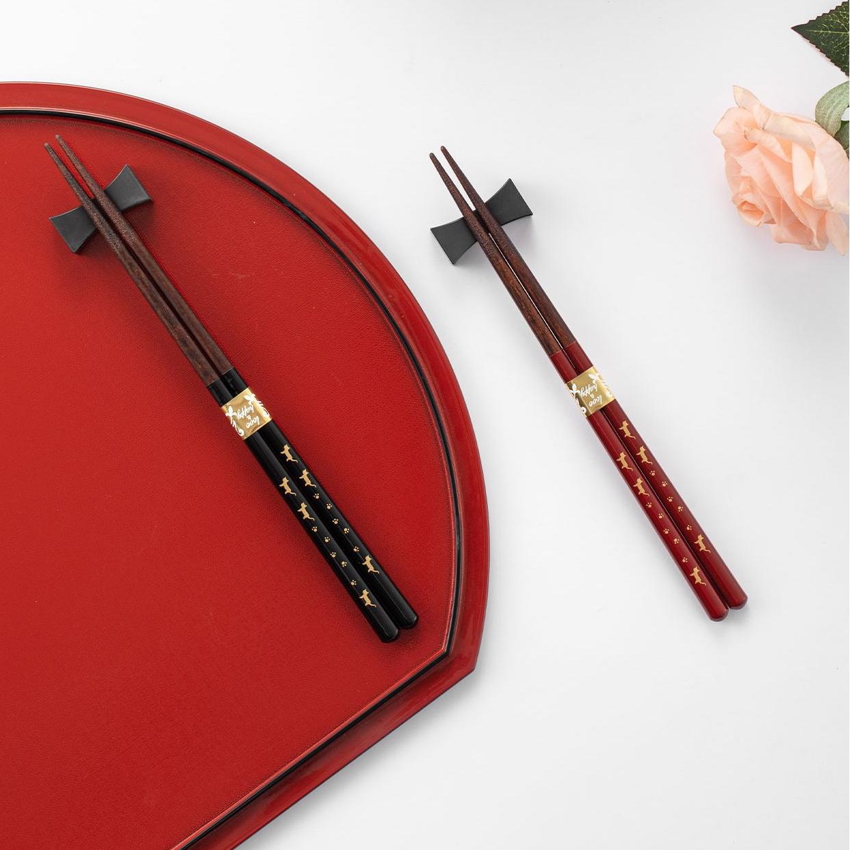 Reusable wooden chopsticks displayed with traditional dinner setting